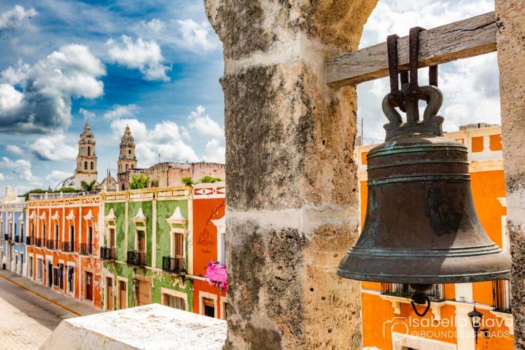 Historic Campeche street with colorful buildings and bell.