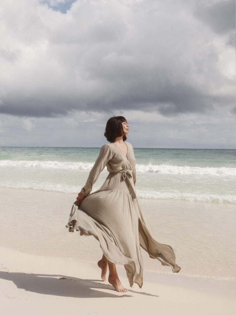 Woman in dress walking on beach