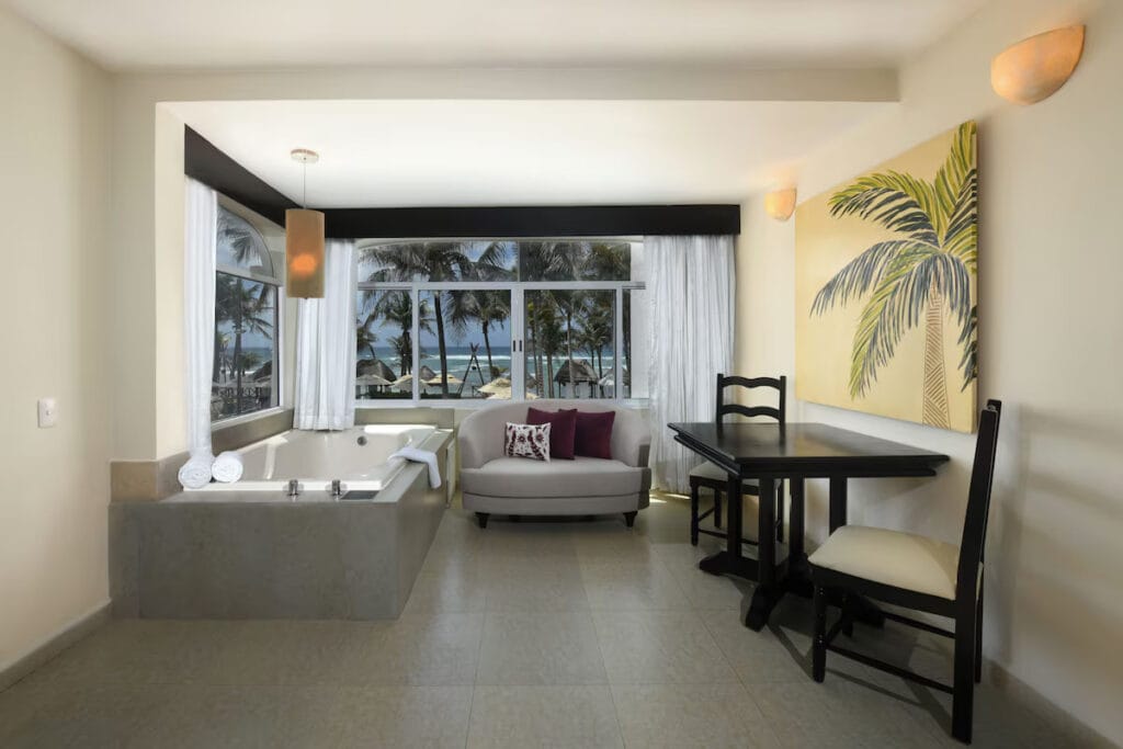 Beachfront hotel room with ocean view and jacuzzi.