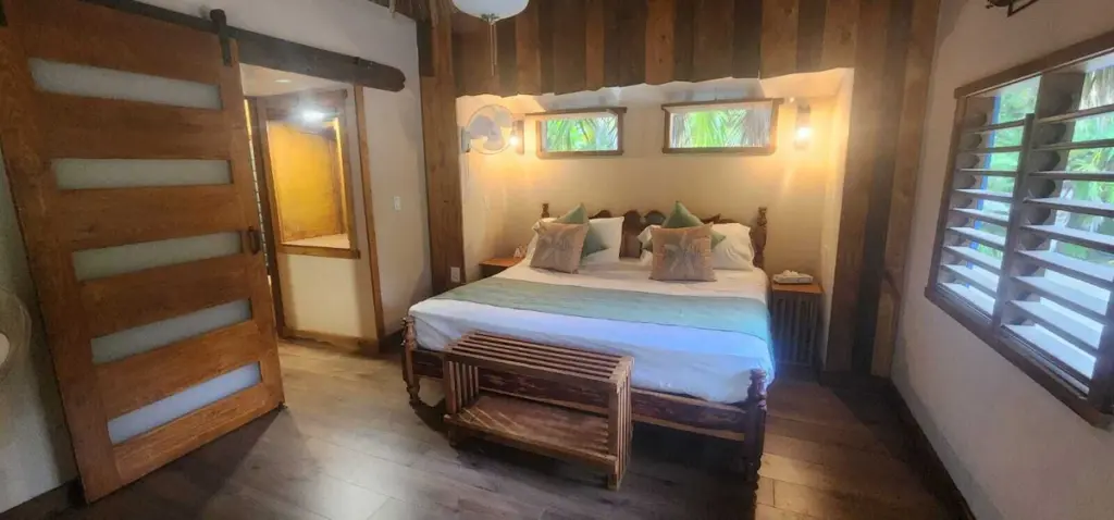 Cozy bedroom with wooden decor and large bed.